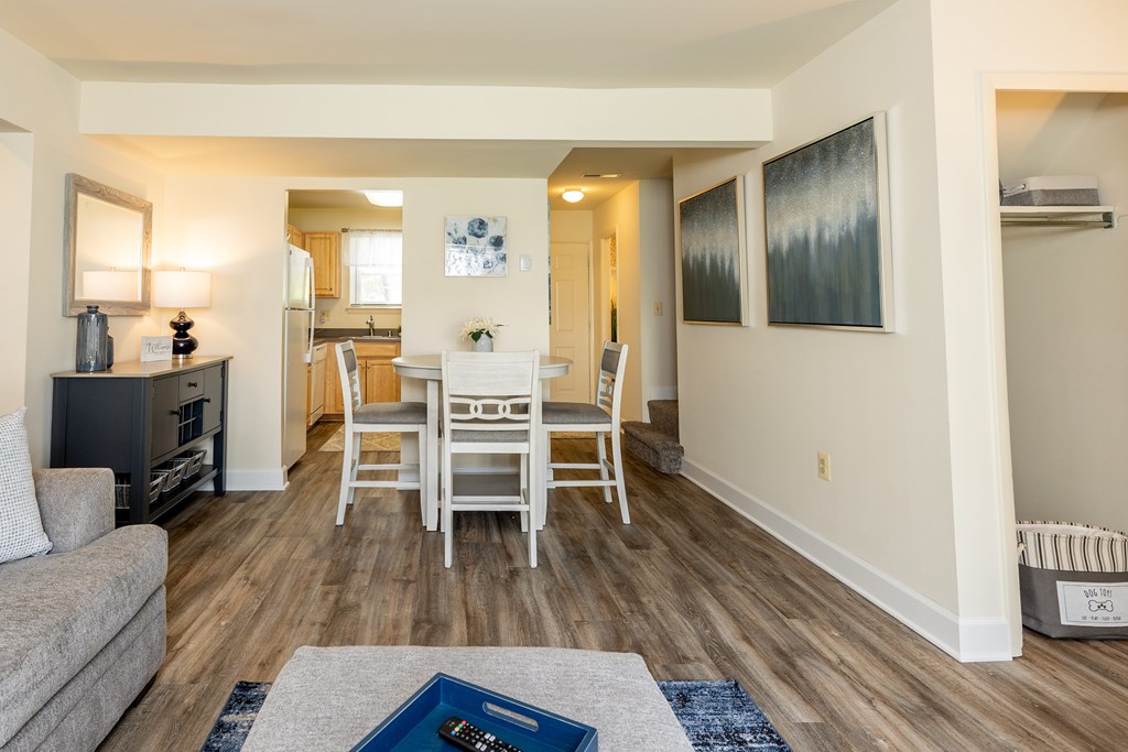 Living room with a tv and a table with chairs at Seven Oaks Townhomes, Edgewood