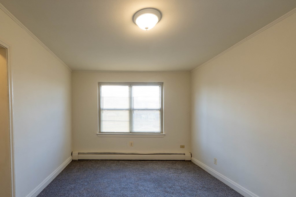 Room with white walls and a single window at Loch Bend Apartments, Baltimore, Maryland, 21234