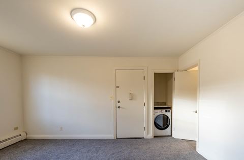 a bedroom with a washer and dryer