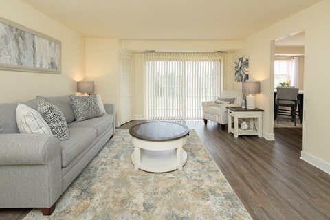 A living room with a grey couch and a round coffee table.