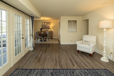 A living room with a chair and a lamp at The Brittany Apartments, Maryland, 21208