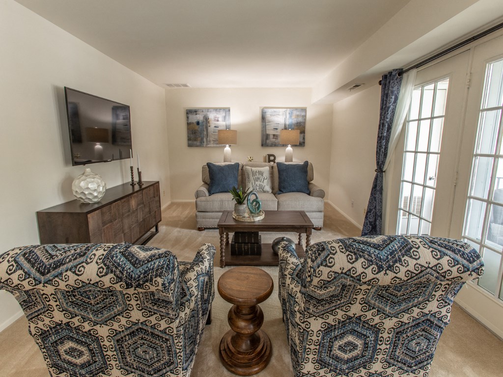 Spacious living room with private balcony  at Brittany Apartments, Baltimore, Maryland