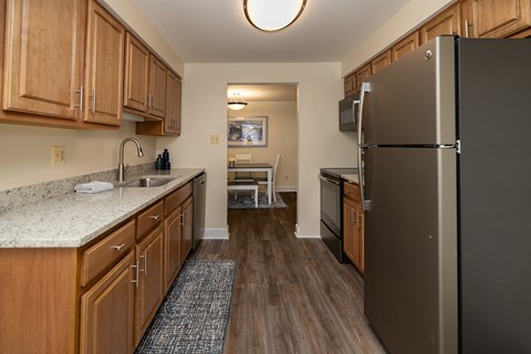 Kitchen with laminate vinyl plank floors and stainless steal appliances