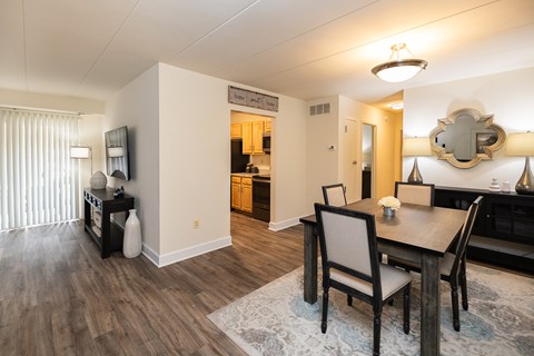 Living and dining room view with table and chairs at Ivy Hall Apartments*, Towson, MD 21204