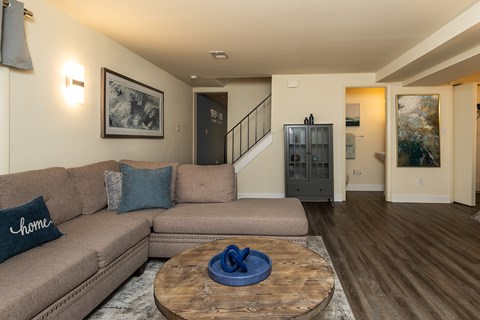 Living room with couch and coffee table at Spring Hill Apartments & Townhomes, Baltimore, MD 21234.