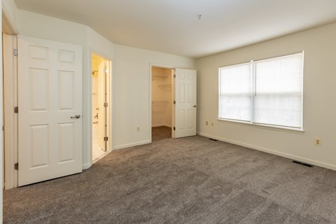 Empty bedroom with a closet and a window at Carlson Woods Townhomes, Baltimore