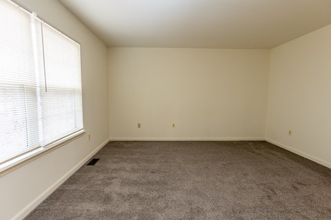 an empty room with carpet and window at Carlson Woods Townhomes, Baltimore, MD, 21244