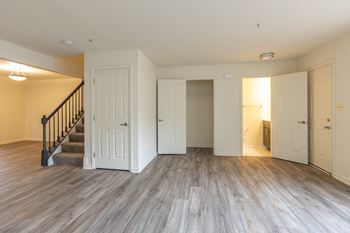 living room in a house with a staircase in the background at Carlson Woods Townhomes, Baltimore, MD