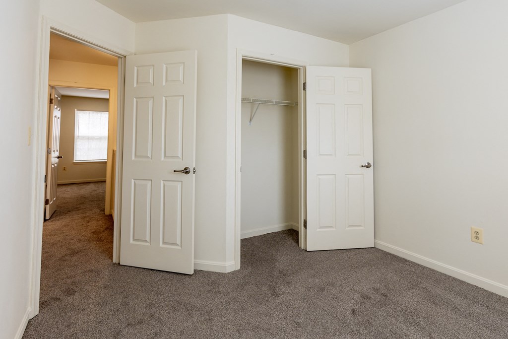 a bedroom with two closets and a carpeted flooring at Carlson Woods Townhomes, Maryland, 21244