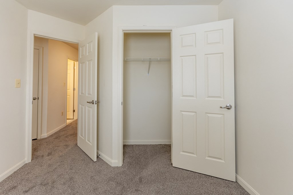 a bedroom with a closet and an open door at Carlson Woods Townhomes, Baltimore