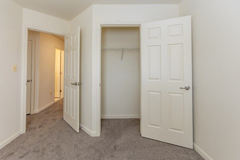 a bedroom with a closet and an open door at Carlson Woods Townhomes, Baltimore