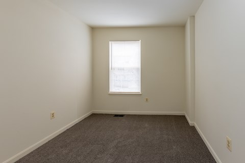 a small empty room with a window and carpet at Carlson Woods Townhomes, Baltimore, MD, 21244