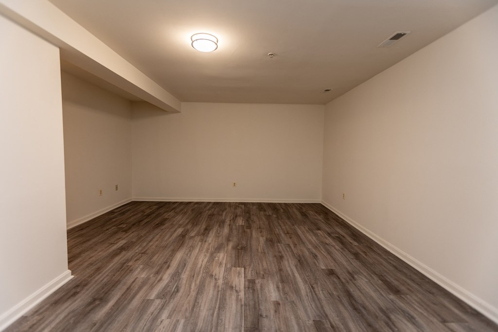 a bedroom with hardwood floors and walls at Carlson Woods Townhomes, Maryland