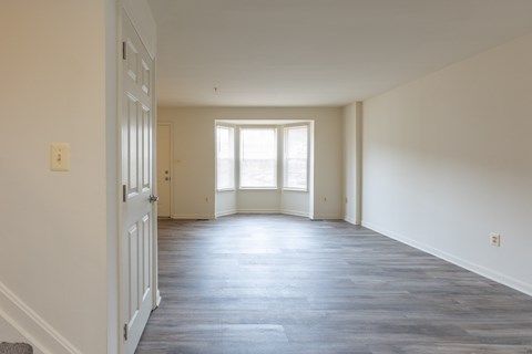 an empty room with white walls and a large window at Carlson Woods Townhomes, Baltimore, MD, 21244
