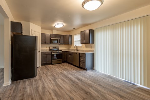 a kitchen with a refrigerator freezer and a stove top oven at Carlson Woods Townhomes, Baltimore, Maryland