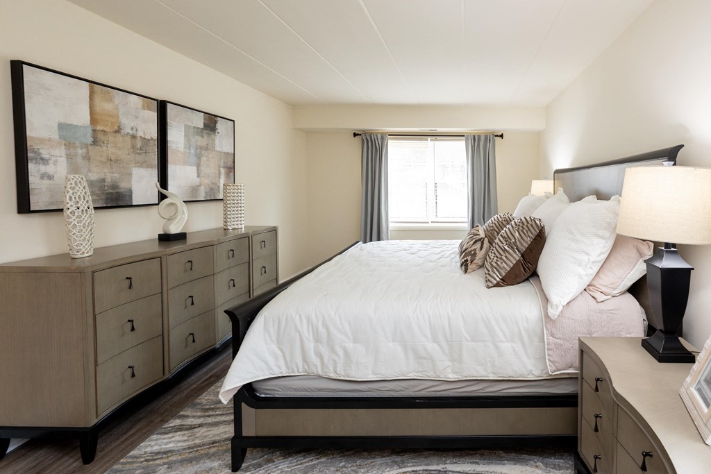 Bedroom with a bed and dressers at Ivy Hall Apartments*, Towson, MD 21204