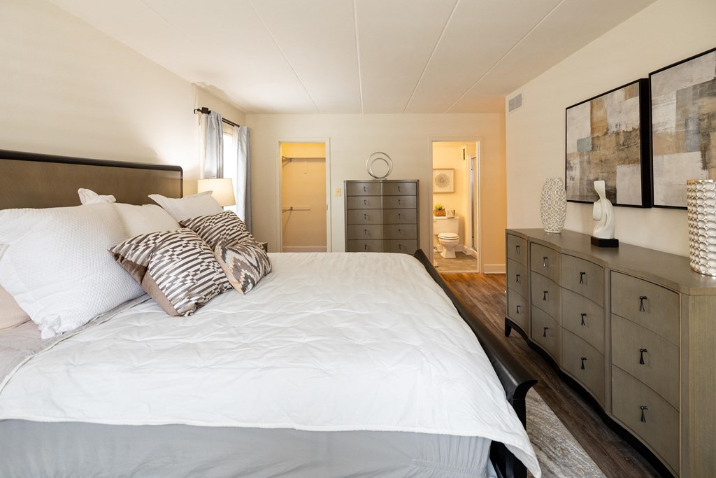 Bedroom with a bed and a dresser at Ivy Hall Apartments*, Towson, MD.