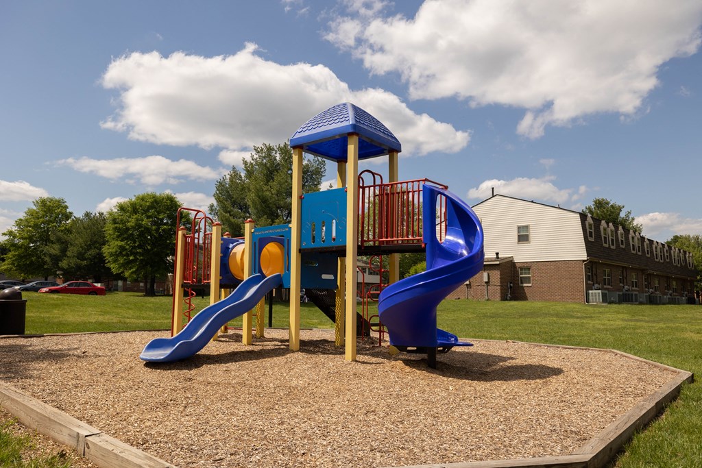 Playground with two slides and a climbing structure at The Orchards at Severn Townhomes*, Severn, MD 21144