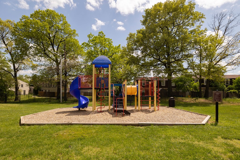 Playground with a blue slide and monkey bars at The Orchards at Severn Townhomes*, Maryland