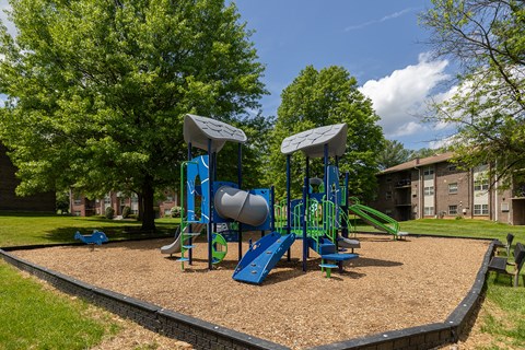 A playground with a blue slide and a green slide.at Deer Park Apartments, Randallstown, MD 21133