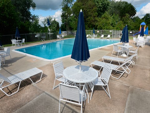 Community pool with lounge chairs at McDonogh Village Apartments & Townhomes, Randallstown, Maryland