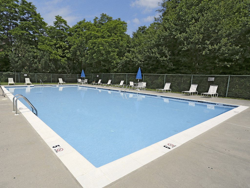 Beautiful private swimming pool with lounge chairs  at Spring Hill Apartments & Townhomes, Baltimore, MD 21234