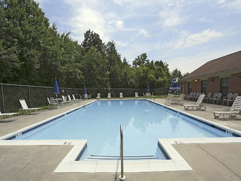 Beautiful private swimming pool with lounge chairs at Spring Hill Apartments & Townhomes, Baltimore
