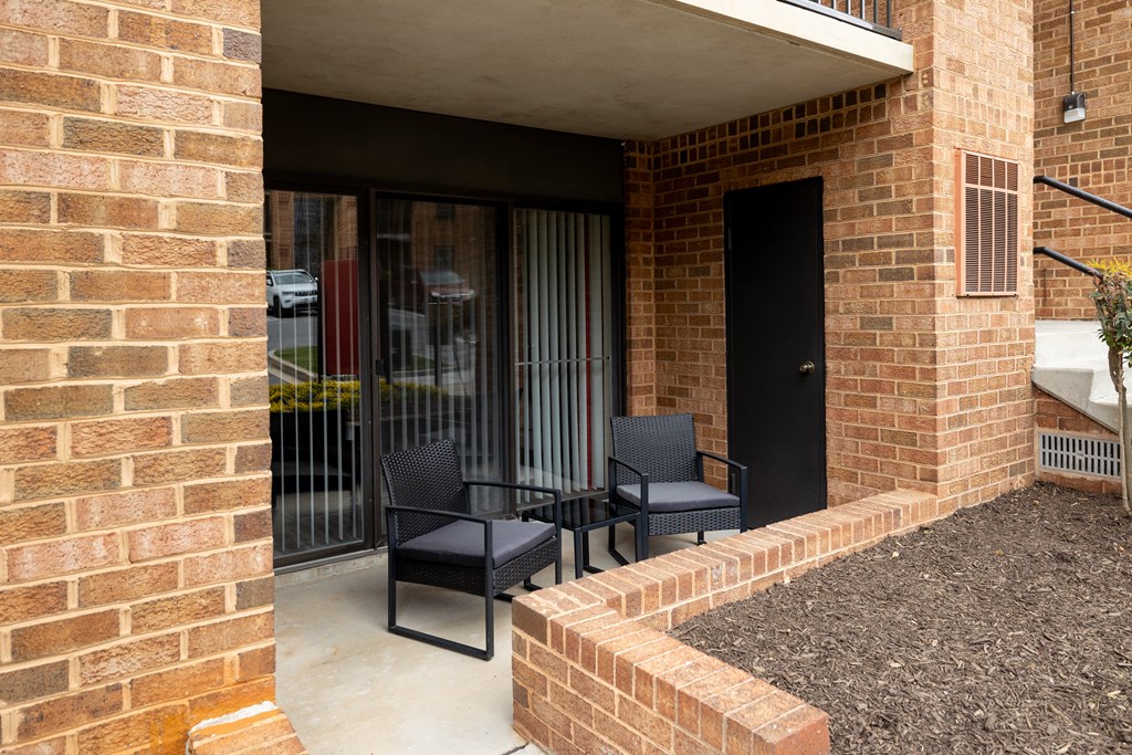 Porch with two chairs and a table at Ivy Hall Apartments*, Towson, MD 21204.