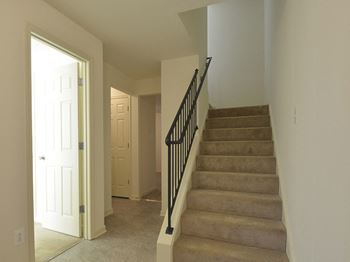 View from the bottom of the stairs looking into the hallway at The Pointe at Manorgreen Townhomes, Baltimore Maryland