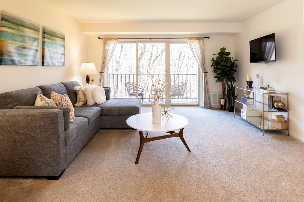 Living room with a gray couch and a white coffee table at Village of Pine Run Apartments & Townhomes*, Maryland
