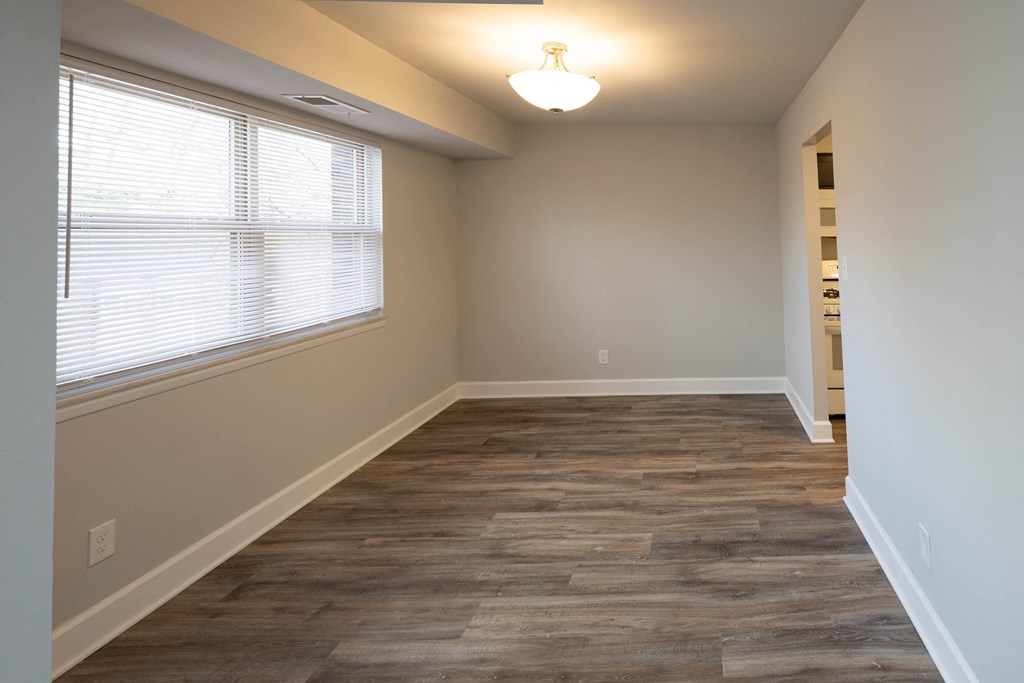 Bedroom with a hardwood floor and a large window at McDonogh Village Apartments & Townhomes, Randallstown, 21133