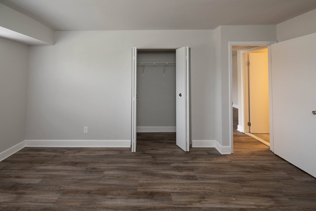 Bedroom with grey walls and wood floor at McDonogh Village Apartments & Townhomes, Randallstown