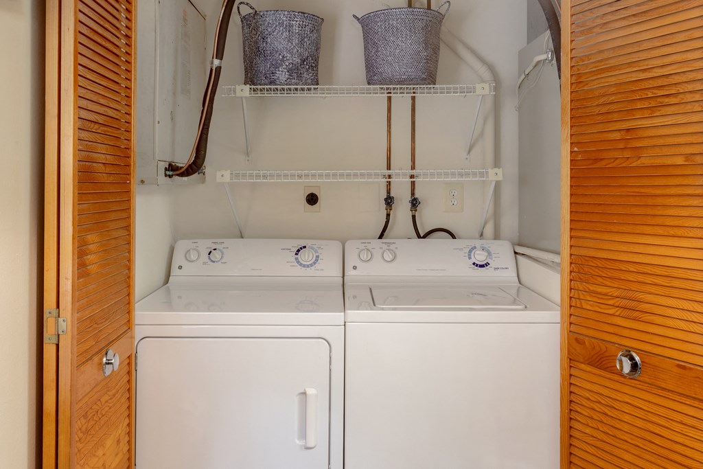A small laundry room with a washer and dryer at Spring Hill Apartments & Townhomes, Baltimore