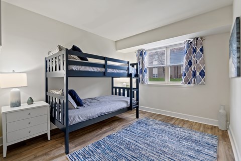 A bedroom with a bunk bed and a dresser at Woodsdale Apartments in Abingdon, MD