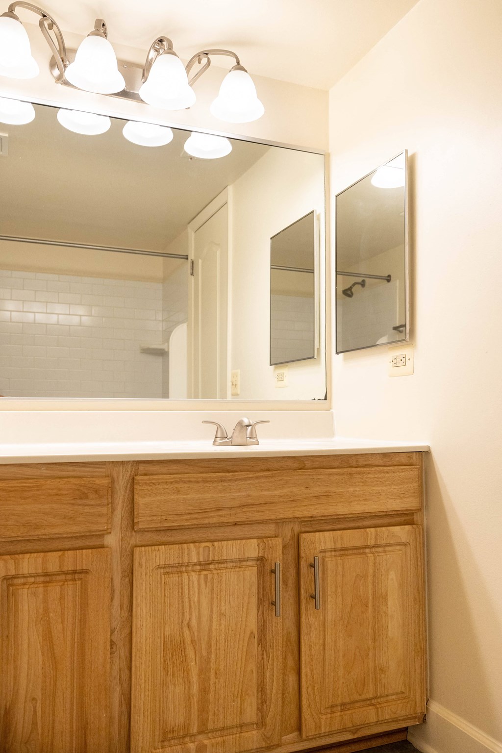a bathroom with a sink and a mirror  at Charlesgate Apartments, Towson