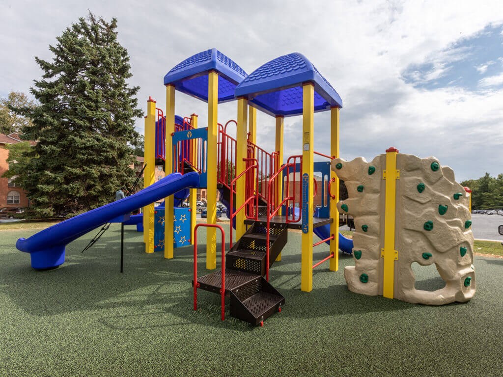 Playground with a blue and yellow play set at Cromwell Valley Apartments, 15 Treeway Court, 2A, Towson
