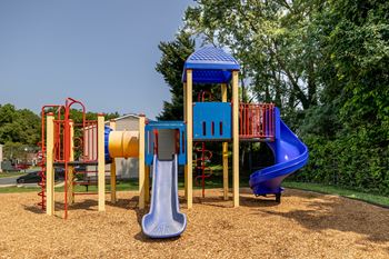 a playground with a swing set and a slide at Seven Oaks Townhomes, Edgewoode, MD, 21040