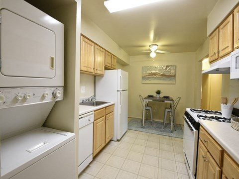 Stacked washer and dryer and eat in space at Deer Park Apartments at Deer Park Apartments, Randallstown, 21133