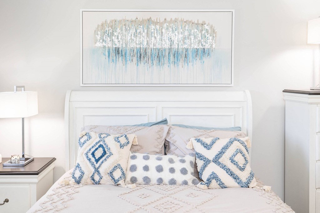 A bedroom with a white headboard and blue and white pillows at Fairbrook Park, Baltimore, MD