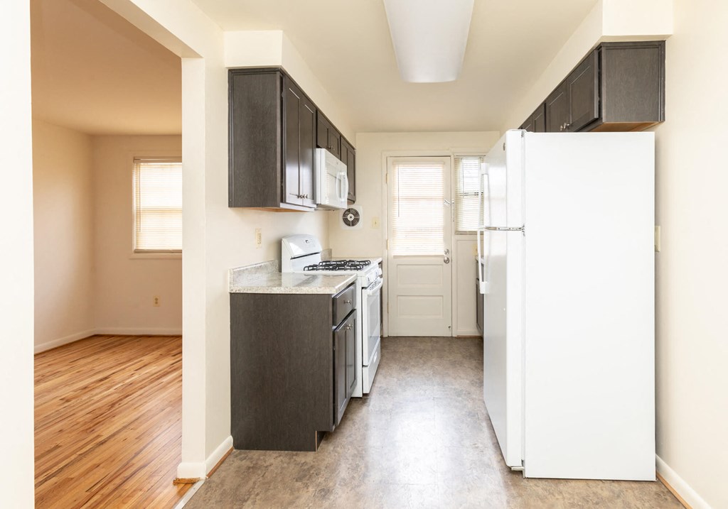 A kitchen with a white refrigerator at Foxridge Townhomes, Maryland, 21221