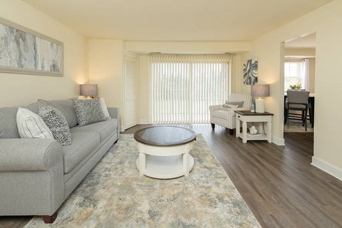 A living room with a grey couch and a round coffee table.