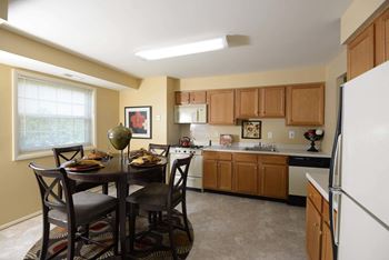 Kitchen and dining room with a table and chairs at Security Park Apartments*, Maryland, 21244