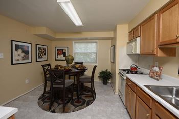 Kitchen and dining room with a table and chairs at Security Park Apartments*, Windsor Mill