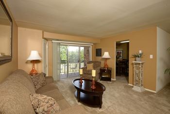 A living room with a couch and a table at Security Park Apartments*, Windsor Mill, 21244