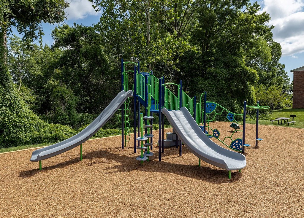 Playground with two slides and a picnic table at Security Park Apartments*, Maryland, 21244