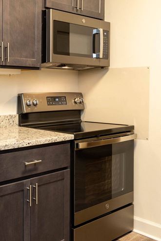 a kitchen with a stove and microwave in a 555 waverly unit