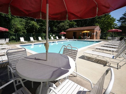 a swimming pool with a table and chairs
