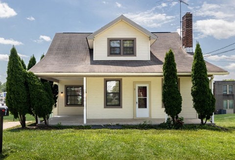 a house with a lawn and trees in front of it at Ivy Hall Apartments*, Towson Maryland
