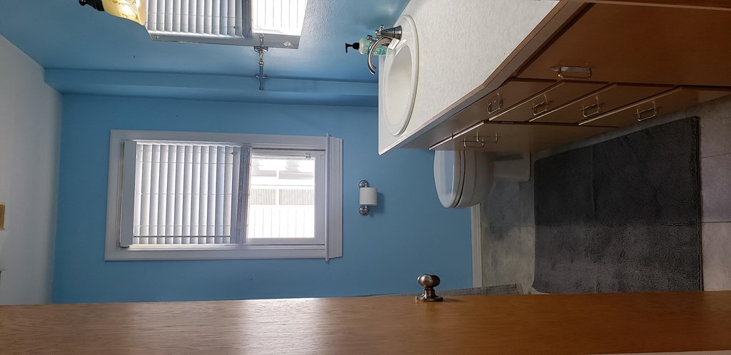 a kitchen with a window and a wooden counter top