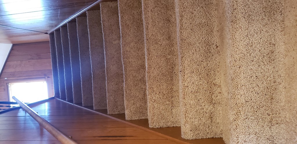 a large wall with a wooden floor and a railing